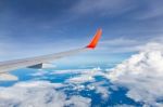 Wing Of The Plane With Blue Sky And Clouds Stock Photo
