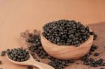 Black Beans On Wooden Floor Stock Photo