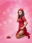 Happy Young Pinup Kneeling Woman Talking On Phone Stock Photo