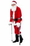 Santa Walking With The Help Of Crutches Stock Photo