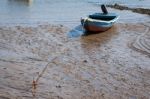 Boat Anchored On The Mud At Holy Island Stock Photo