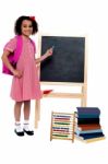 Pretty Schoolgirl Pointing At Chalkboard Stock Photo