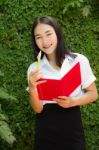 Thai Adult Student University Beautiful Girl Reading Red Book Stock Photo