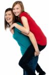 Happy Mother Giving Piggyback Ride To Her Daughter Stock Photo