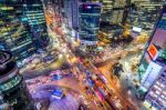 Traffic Speeds Through An Intersection At Night In Gangnam, Seoul In South Korea Stock Photo