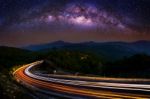 Milky Way And Car Light On Road At Doi Inthanon National Park In The Night, Chiang Mai, Thailand Stock Photo