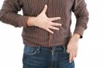 Man Holding His Stomach In Pain Or Indigestion Stock Photo