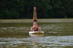 Headstand On Paddleboard Stock Photo