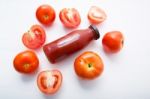 Fresh Tomatoes Juice In Bottle And Fresh Tomatoes Slices On Whit Stock Photo