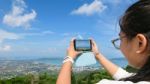 Young Women Taking Photograph With Mobile Phones Stock Photo