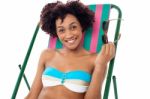 Glamorous Woman In Lingerie Relaxing On A Deckchair Stock Photo