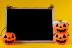 Halloween Pumpkins Bucket With Chalkboard On Yellow Background , Stock Photo