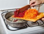 Woman Cooks Carrots And Beets Stock Photo