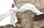Attractive Woman In White Dress Looks Like Angel Stock Photo