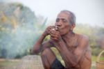 Older Asian Men Sit Smoking Stock Photo