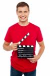 Young Guy Holding Clapperboard Stock Photo