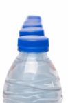 Row Of Plastic Water Bottles Isolated On A White Background Stock Photo