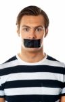 Male Mouth Covered With Tape Stock Photo