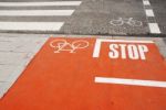 Orange Bicycle Lane With A Stop Sign Stock Photo
