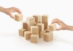 Two Hands Playing Wooden Box On Isolated Background Stock Photo