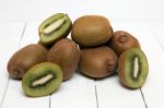 Tasty Kiwi Fruits Isolated On A White Wooden Background Stock Photo