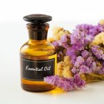 Bottle Of Essential Oil With Flower Stock Photo