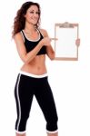 Fitness Woman Showing A Blank Clip Board Stock Photo