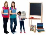 Happy Students Standing In Classroom Stock Photo