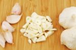 Garlic Preparation Ways On A Cutting Board Stock Photo