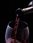 Red Vine Pouring From Bottle Stock Photo