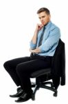 Pensive Businessman Sitting On The Chair Stock Photo
