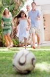 Family Members Playing Soccer Stock Photo