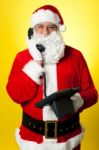 Smiling Aged Santa Attending Phone Call Stock Photo