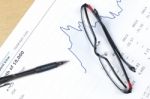 Pen, Notebook, Glasses And Financial Report Stock Photo