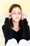 Woman Having Headache At Home Stock Photo