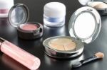 Woman Cosmetic Foundation And Eyeshadow And Lip Gloss And Brush Stock Photo