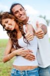 Smiling Couple Showing Thumbs Up Stock Photo