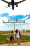 Two Girls Hitchhiking A Plane Stock Photo
