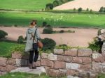 Woman Looking At The Cheshire Countryside From Beeston Castle Stock Photo
