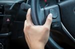 A Woman Hand Pushes The Volume Control Button On A Steering Wheel Stock Photo