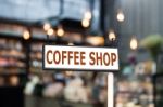 Coffee Shop Signboard With Coffee Shop Blurred Background Stock Photo