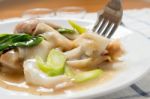 Rad Na, Famous Thai Chinese Style Wide Rice Noodle Dish With Tasty Tender Pork With Thick Gravy Sauce. Close Up With Fork Stock Photo