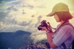 Vintage Style Hiker Looking Photo On Camera Stock Photo