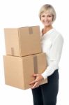 Middle Aged Woman Moving Packed Boxes Stock Photo