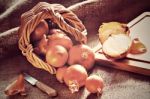 Loose Onions Scattered From Wicker Basket Stock Photo