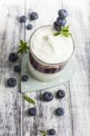 Glass Of Yogurt With Fresh Blueberries Stock Photo