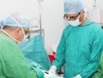 Surgeons Working In Operation Room Stock Photo