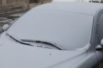 Parked Car Covered With The First Snow In Winter Stock Photo