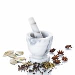 Marble Mortar And Pestle With Assorted Spices On White Backgroun Stock Photo