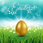 Gold Egg On Fresh Spring Grass For Easter Day Greeting Card Stock Photo